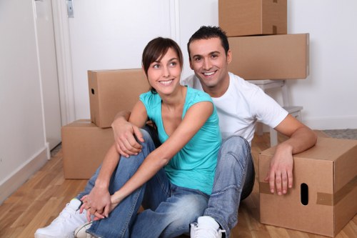Packers preparing fragile household items for transport
