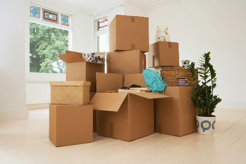 Professional movers carrying items in a Notting Hill property