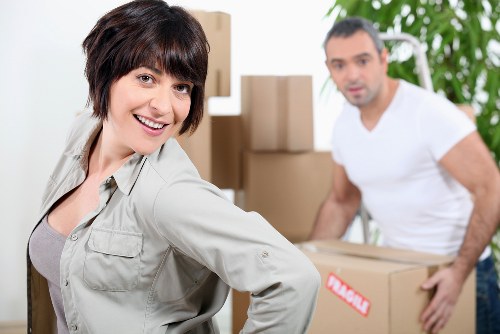 Packed office boxes and labelled equipment for a commercial relocation